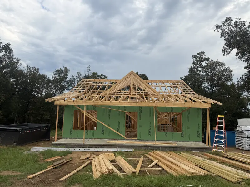 Green-wrapped home with roof framing