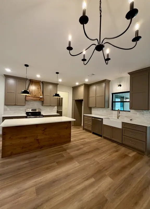 Kitchen with taupe shaker cabinets and wood island